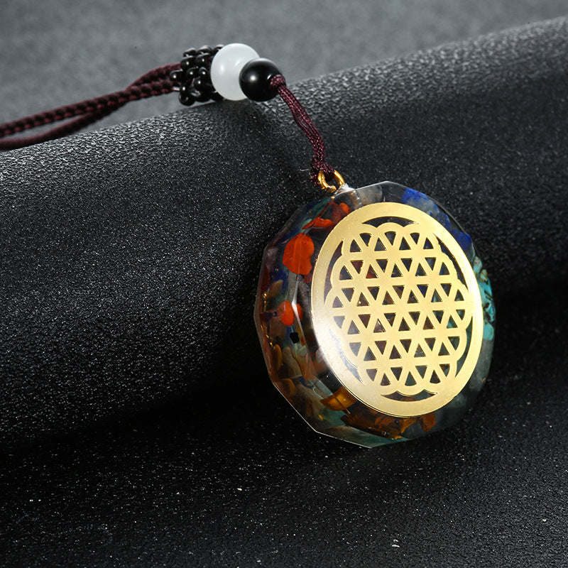 Orgone crystal chip pendant with flower of life emblem