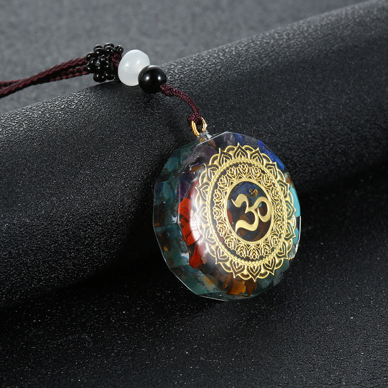 Orgone crystal chip pendant with om emblem