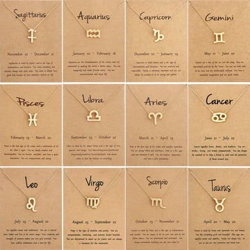 Gold zodiac symbol necklaces on meaning cards, all 12 signs