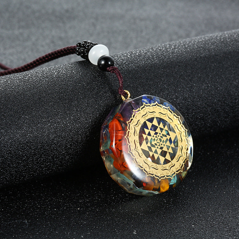 Orgone crystal chip pendant with sri yantra emblem