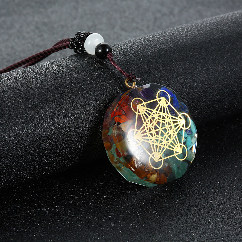 Orgone crystal chip pendant with tree of life emblem