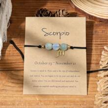 Scorpio dainty zodiac charm bracelet on kraft card