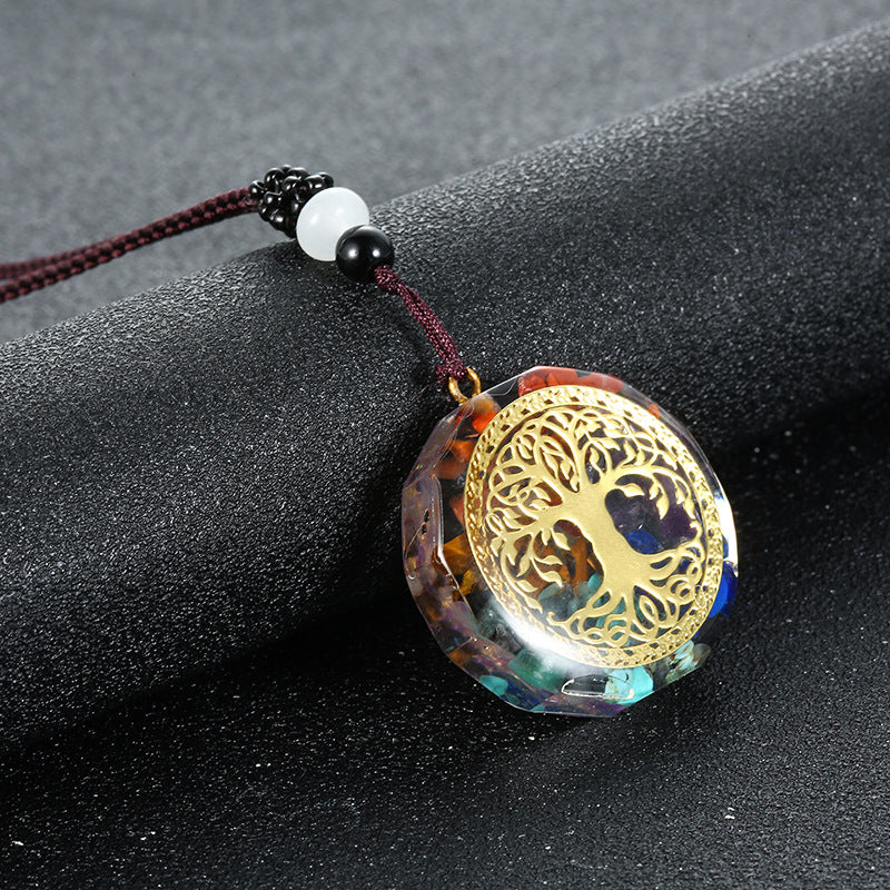 Orgone crystal chip pendant with tree of life emblem